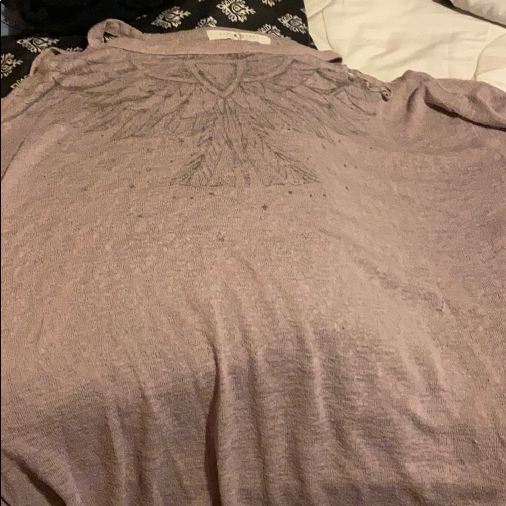 A purple long sleeve open shoulder top